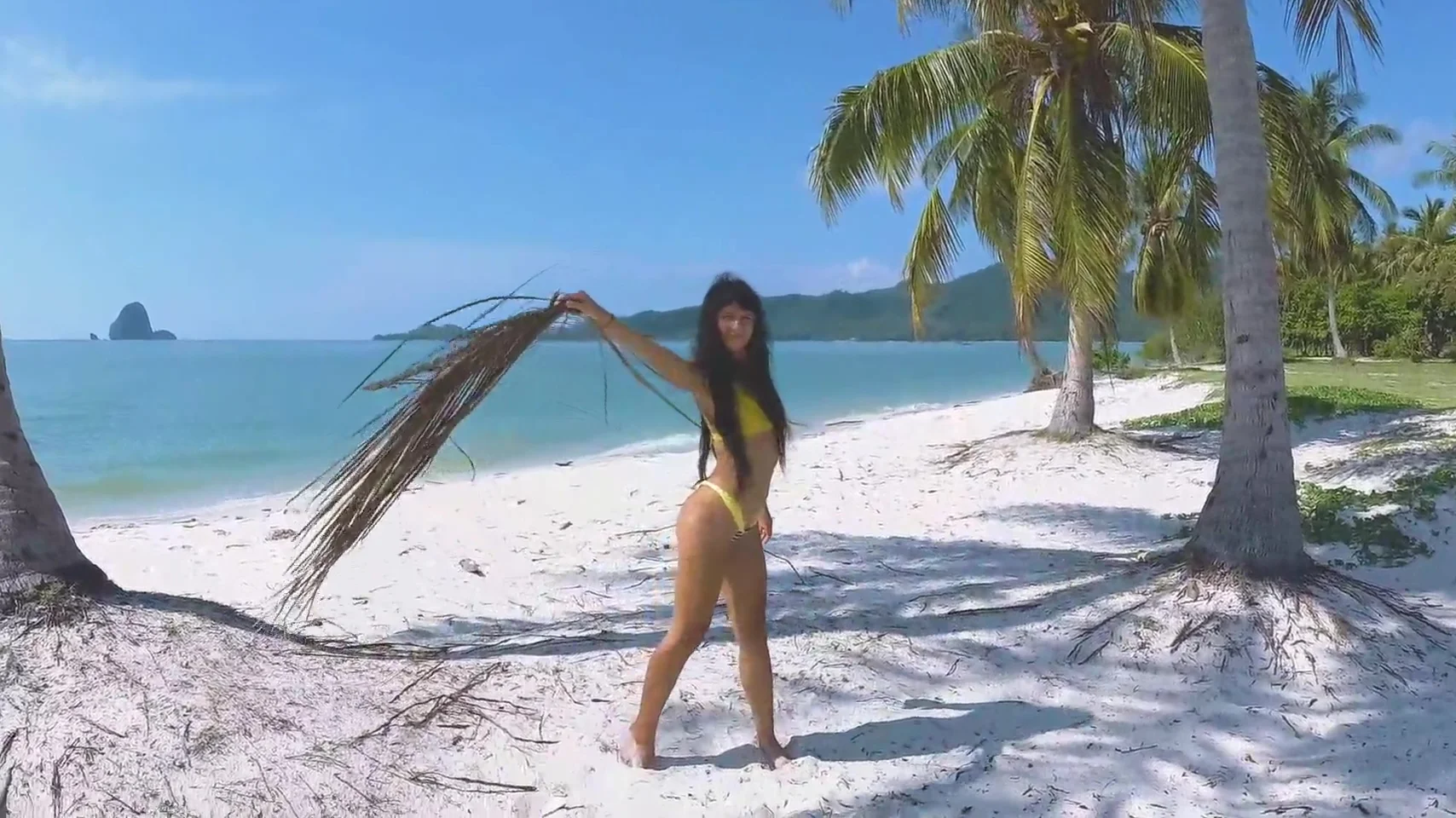 Micro bikini tease by sexy teen 18+ who walks on a beach