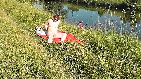Wild Beach. Sexy Milf Platinum Naked Sunbathing On River Bank, Random Fisherman Guy Watches. Naked In Public. Nude Beach